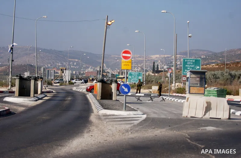 Israeli soldiers stand guards after the clashes between Palestinians and Jewish settlements close to the northern West Bank village of Burin on July 26, 2010, which began when Israeli troops removed two mobile homes set...