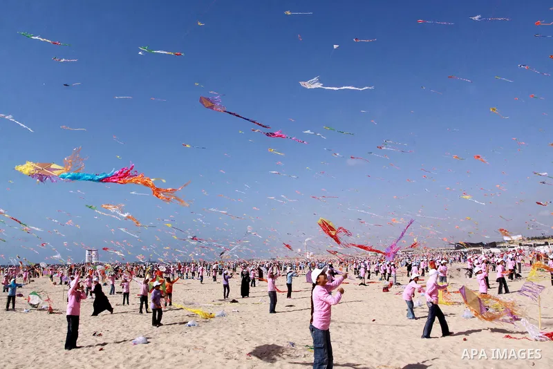Palestinian children fly kites along the beach during a U.N. run summer camp in Gaza City on July 29, 2010. Thousands of children in the Gaza Strip gathered to break the world record for kite flying for the second time....