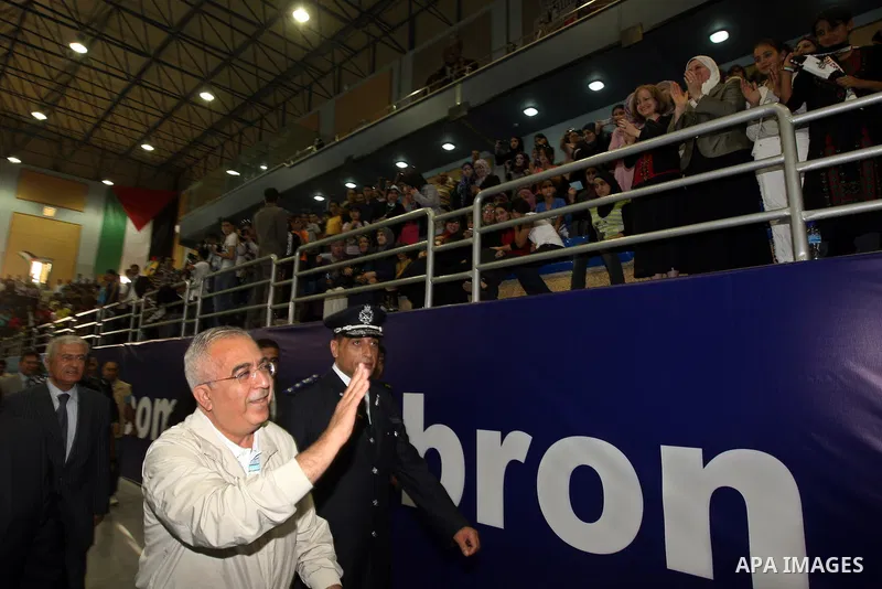 Palestinian Prime Minister Salam Fayyad attends the opening celebration of the closed Hebron sport hall in the West Bank city of Hebron on July 30,2010. Photo by Mustafa Abu Dayeh / Pool