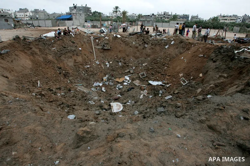 Palestinians inspect a destroyed security site of Hamas after Israeli air raid in al-Buriej refugee camp, central Gaza Strip, July 31, 2010. One Palestinian was found killed several hours after Israeli jet fighters hit l...