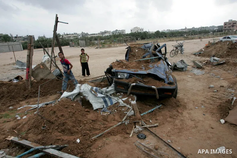 Palestinians inspect a destroyed security site of Hamas after Israeli air raid in al-Buriej refugee camp, central Gaza Strip, July 31, 2010. One Palestinian was found killed several hours after Israeli jet fighters hit l...