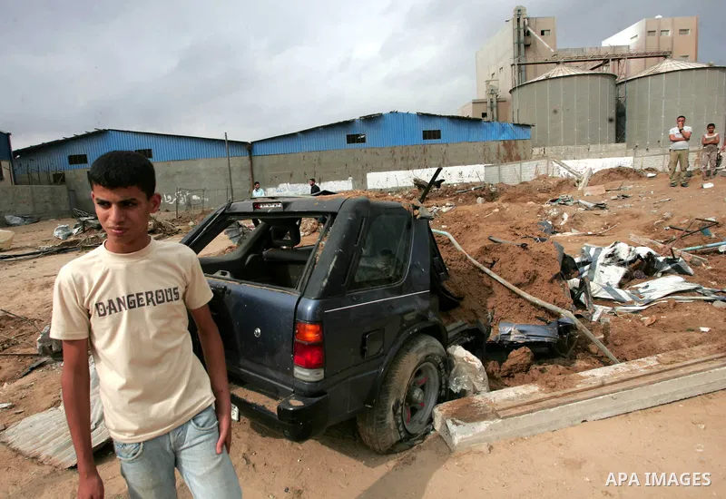 Palestinians inspect a destroyed security site of Hamas after Israeli air raid in al-Buriej refugee camp, central Gaza Strip, July 31, 2010. One Palestinian was found killed several hours after Israeli jet fighters hit l...