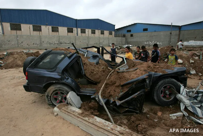Palestinians inspect a destroyed security site of Hamas after Israeli air raid in al-Buriej refugee camp, central Gaza Strip, July 31, 2010. One Palestinian was found killed several hours after Israeli jet fighters hit l...