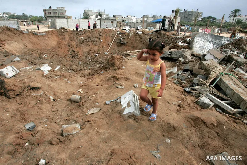 Palestinians inspect a destroyed security site of Hamas after Israeli air raid in al-Buriej refugee camp, central Gaza Strip, July 31, 2010. One Palestinian was found killed several hours after Israeli jet fighters hit l...
