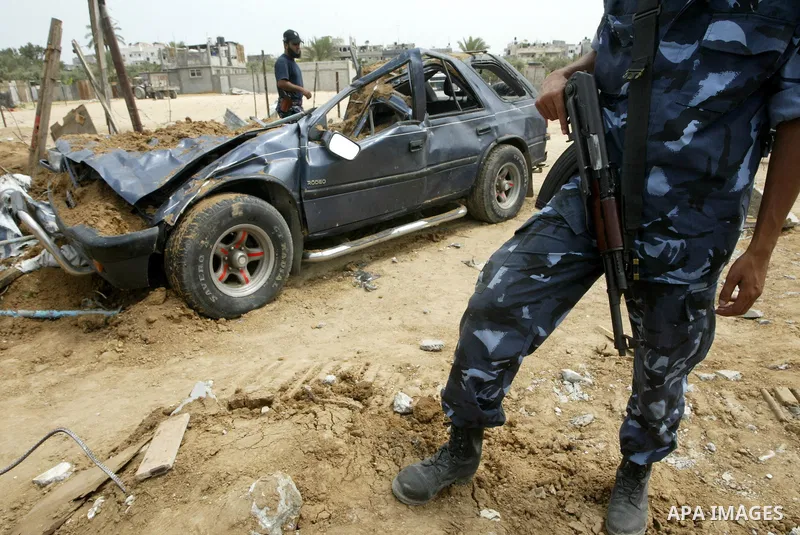 Members of Hamas security forces inspect a destroyed security site after Israeli air raid in al-Buriej refugee camp, central Gaza Strip, July 31, 2010. One Palestinian was found killed several hours after Israeli jet fig...