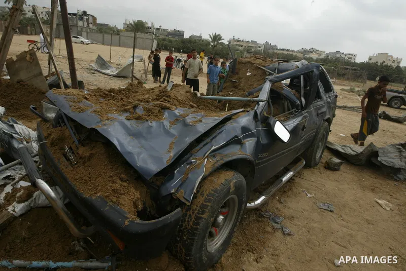 Palestinians inspect a destroyed security site of Hamas after Israeli air raid in al-Buriej refugee camp, central Gaza Strip, July 31, 2010. One Palestinian was found killed several hours after Israeli jet fighters hit l...