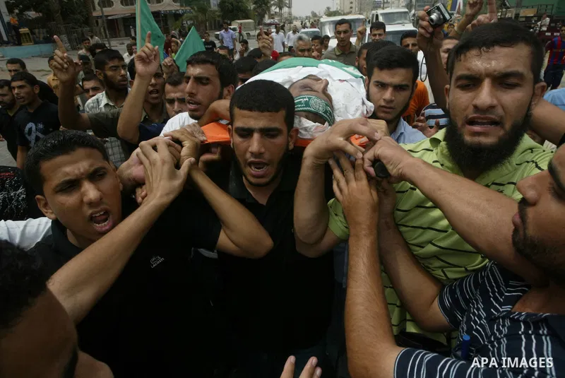 Palestinians carry the body of Issa Batran, a Hamas military commander and rocket maker, during his funeral in al-Buraij camp in the central Gaza Strip July 31, 2010. An Israeli air strike killed Batran in the Gaza Strip...