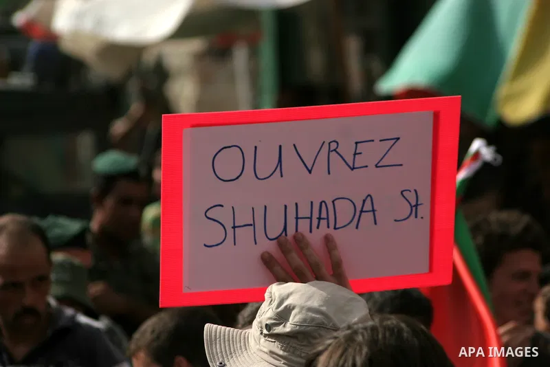 Palestinian and foreign activists take part in a weekly protest against the closing of Al-Shuhada Street in the West Bank old city of Hebron on July 31,2010. Palestinians, Israelis and International peace activists prote...