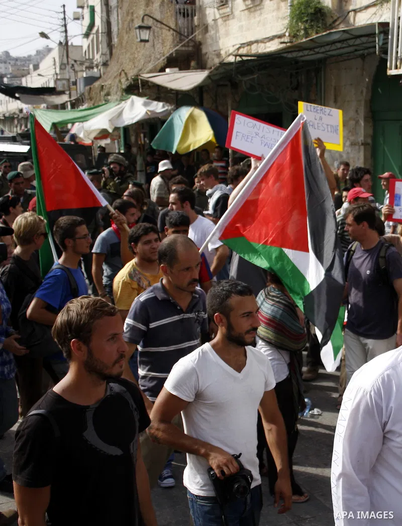 Palestinian and foreign activists take part in a weekly protest against the closing of Al-Shuhada Street in the West Bank old city of Hebron on July 31,2010. Palestinians, Israelis and International peace activists prote...