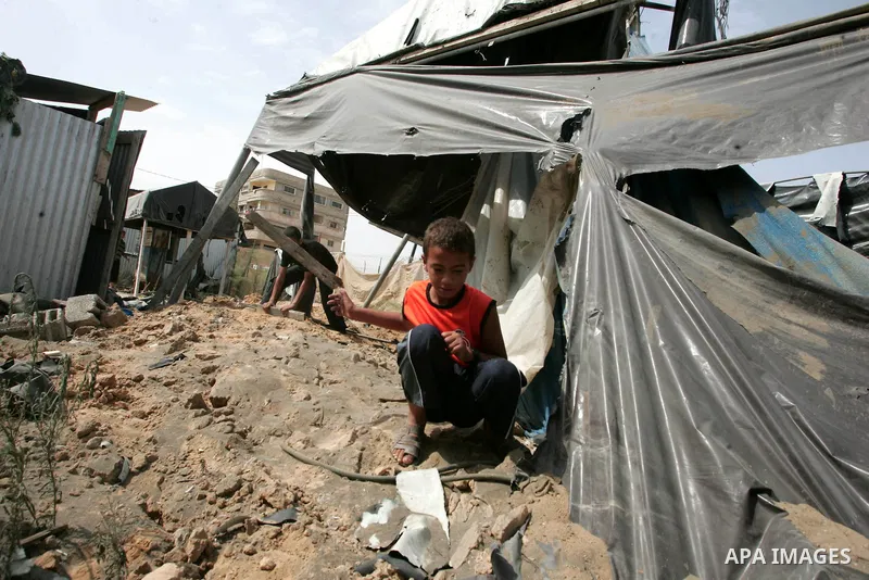 Palestinian children play at one of two smuggling tunnels damaged in two pre-dawn Israeli air strikes in Rafah town along the border with Egypt in the southern Gaza Strip on August 01, 2010, in which one person was injur...