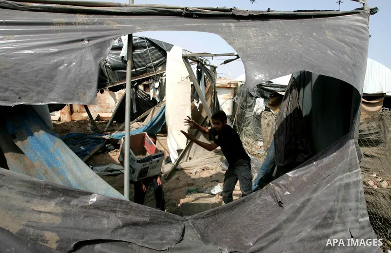 Palestinian children play at one of two smuggling tunnels damaged in two pre-dawn Israeli air strikes in Rafah town along the border with Egypt in the southern Gaza Strip on August 01, 2010, in which one person was injur...