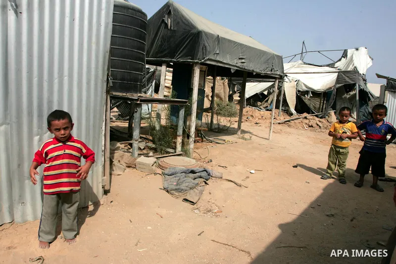 Palestinian children play at one of two smuggling tunnels damaged in two pre-dawn Israeli air strikes in Rafah town along the border with Egypt in the southern Gaza Strip on August 01, 2010, in which one person was injur...