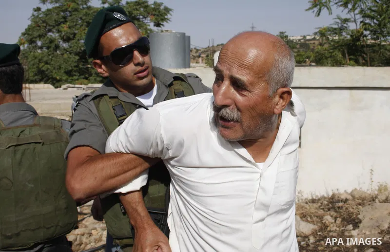 Israeli border policemen arrest Palestinian man during scuffles in the West Bank city of Hebron on August 2, 2010 after Israeli authorities destroyed the irrigation system in the Jaber family's land. Photo by Mamoun Wazw...