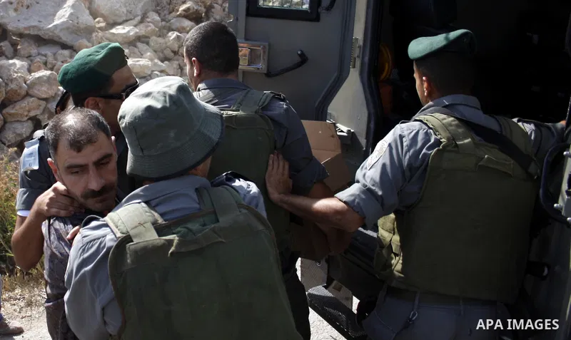 Israeli border policemen arrest Palestinian Fadel Jaber during scuffles in the West Bank city of Hebron on August 2, 2010 after Israeli authorities destroyed the irrigation system in the Jaber family's land. Photo by Mam...