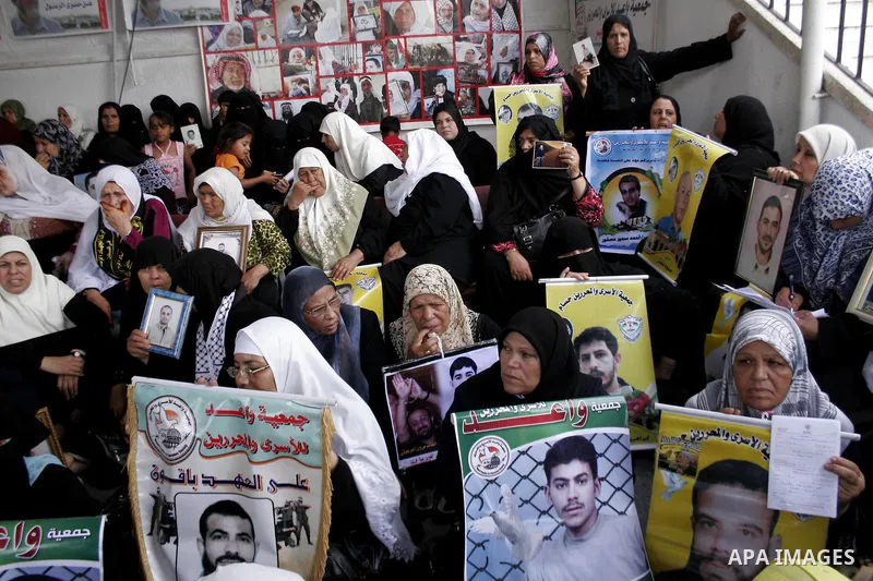 Palestinian women hold pictures of jailed relatives during a protest calling for the release of Palestinian prisoners from Israeli jails at the Red Cross office in Gaza City on August 2,2010. Photo by Yousef Deeb