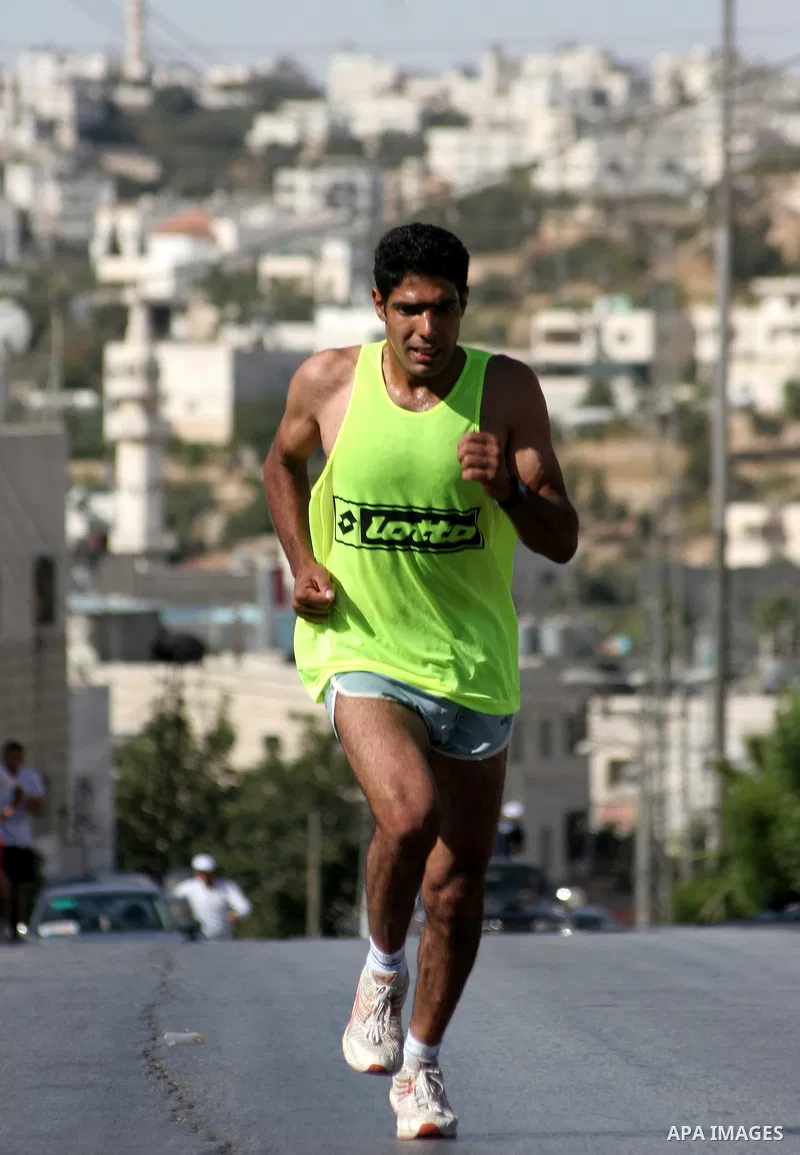 Palestinians run during the marathon in the West Bank city of Hebron on August 6,2010 . Photo by Mamoun Wazwaz