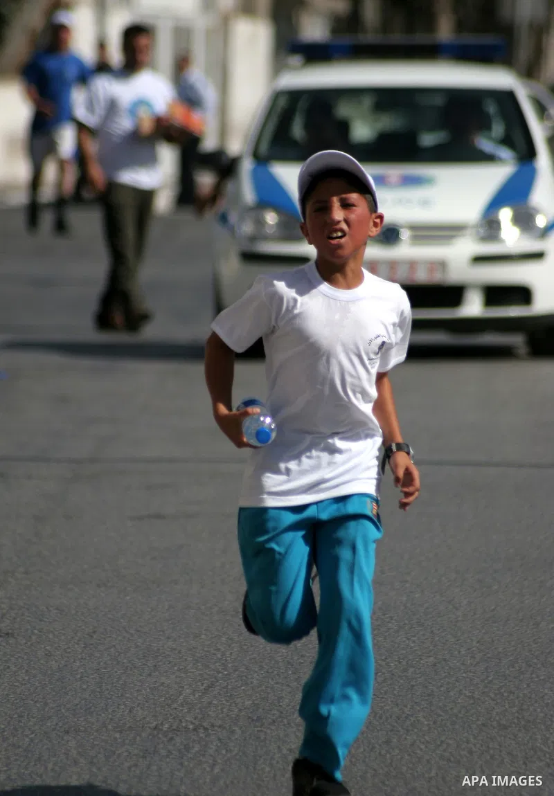 Palestinians run during the marathon in the West Bank city of Hebron on August 6,2010 . Photo by Mamoun Wazwaz