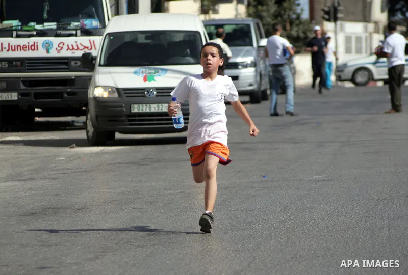 Palestinians run during the marathon in the West Bank city of Hebron on August 6,2010 . Photo by Mamoun Wazwaz