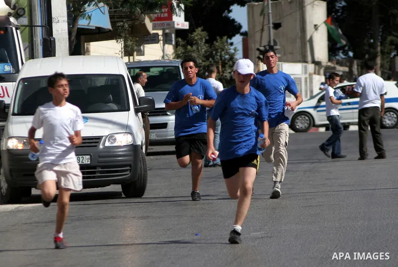 Palestinians run during the marathon in the West Bank city of Hebron on August 6,2010 . Photo by Mamoun Wazwaz