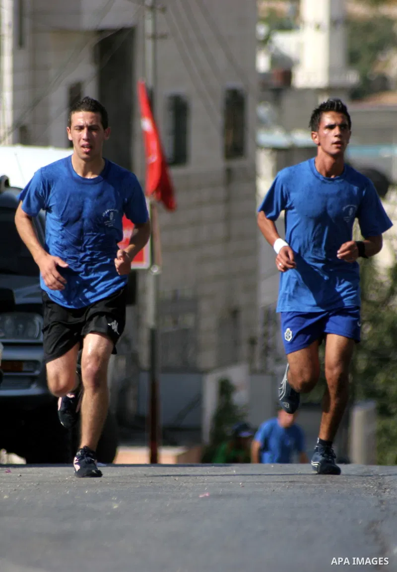 Palestinians run during the marathon in the West Bank city of Hebron on August 6,2010 . Photo by Mamoun Wazwaz