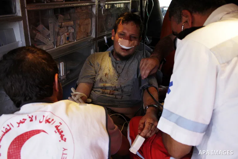 A foreign peace activist receives a treatment after he wounded by the Israeli settlers in the Bouka'a village near the West Bank city of Hebron on August 6,2010 . Photo by Mamoun Wazwaz