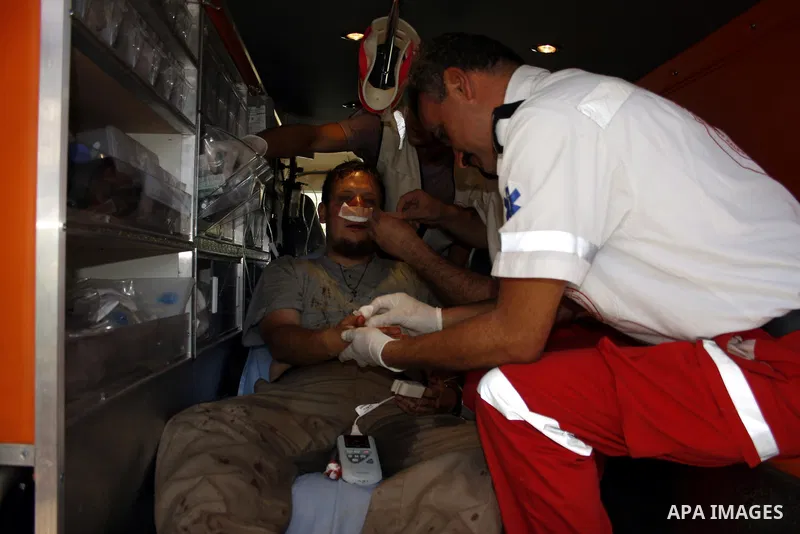A foreign peace activist receives a treatment after he wounded by the Israeli settlers in the Bouka'a village near the West Bank city of Hebron on August 6,2010 . Photo by Mamoun Wazwaz