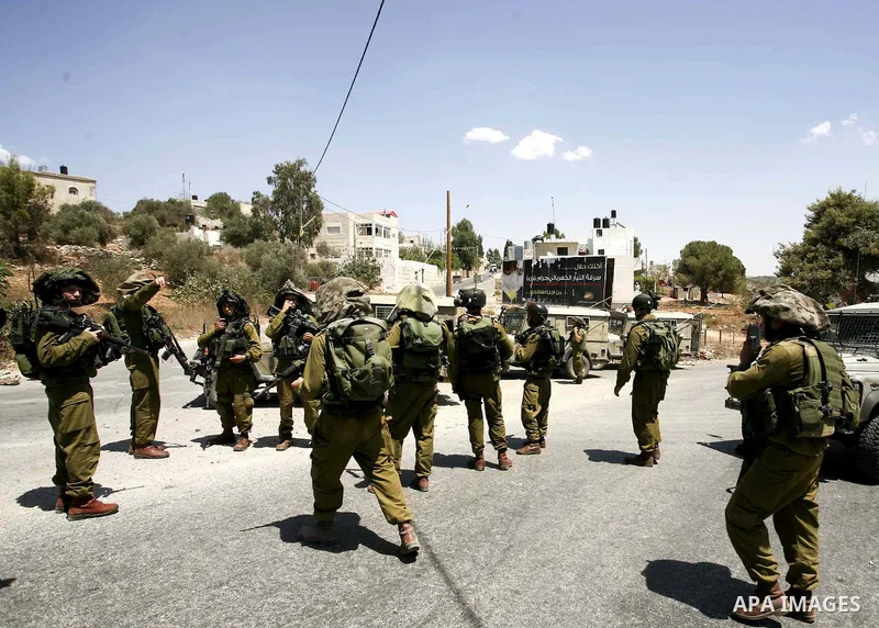 Israeli soldiers take position during a protest in the West Bank village of Nabi Saleh, on 06 August 2010. Residents of the village protest weekly against the neighbouring Jewish settlement of Halamish and the lack of wa...