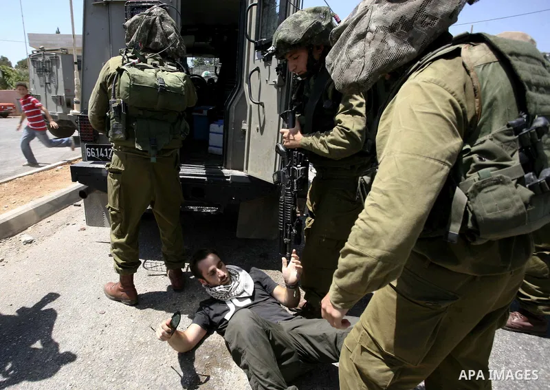 Israeli soldiers detain a demonstrator during a protest in the West Bank village of Nabi Saleh, on 06 August 2010. Residents of the village protest weekly against the neighbouring Jewish settlement of Halamish and the la...