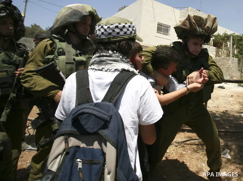 Israeli soldiers detain a demonstrator during a protest in the West Bank village of Nabi Saleh, on 06 August 2010. Residents of the village protest weekly against the neighbouring Jewish settlement of Halamish and the la...