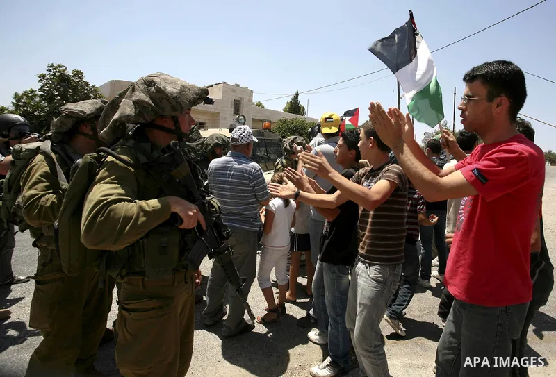 Demonstrators take part in a protest in the West Bank village of Nabi Saleh, on 06 August 2010. Residents of the village protest weekly against the neighbouring Jewish settlement of Halamish and the lack of water supply....
