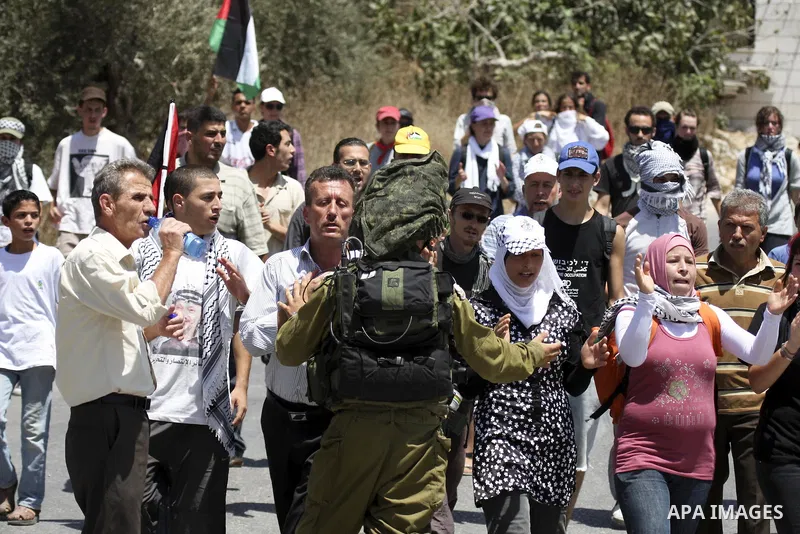 Demonstrators take part in a protest in the West Bank village of Nabi Saleh, on 06 August 2010. Residents of the village protest weekly against the neighbouring Jewish settlement of Halamish and the lack of water supply....