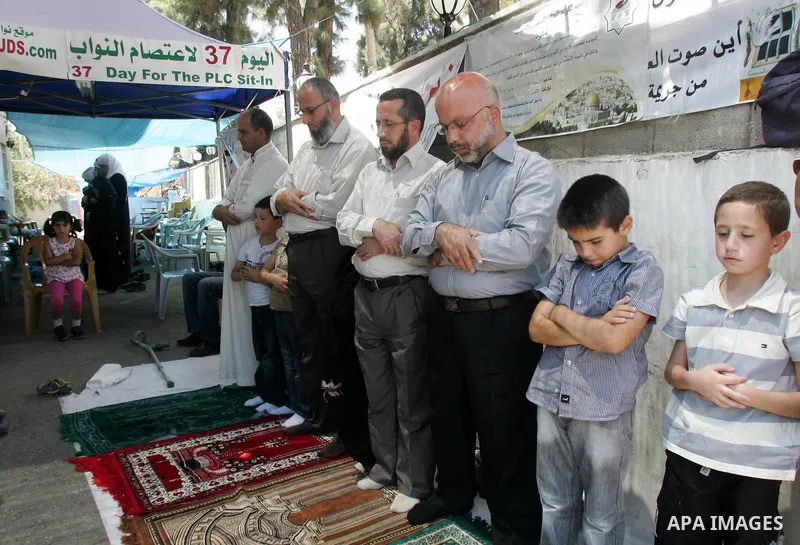 Palestinian lawmakers from Hamas movements Ahmed Atwan, Khaled Abu Arafieh and Muhammad Totah attending the Friday prayer at the International Red Cross Committee (ICRC), headquarter in East Jerusalem August 6,2010. The...