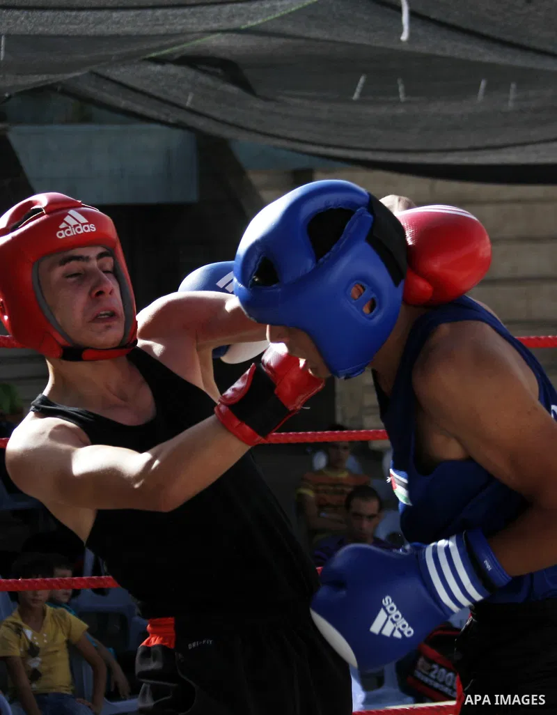 Palestinian players participate in a boxing match in the West Bank city of Hebron on August 6,2010. The players came from the different occupied West Bank cities. Photo by Mamoun Wazwaz