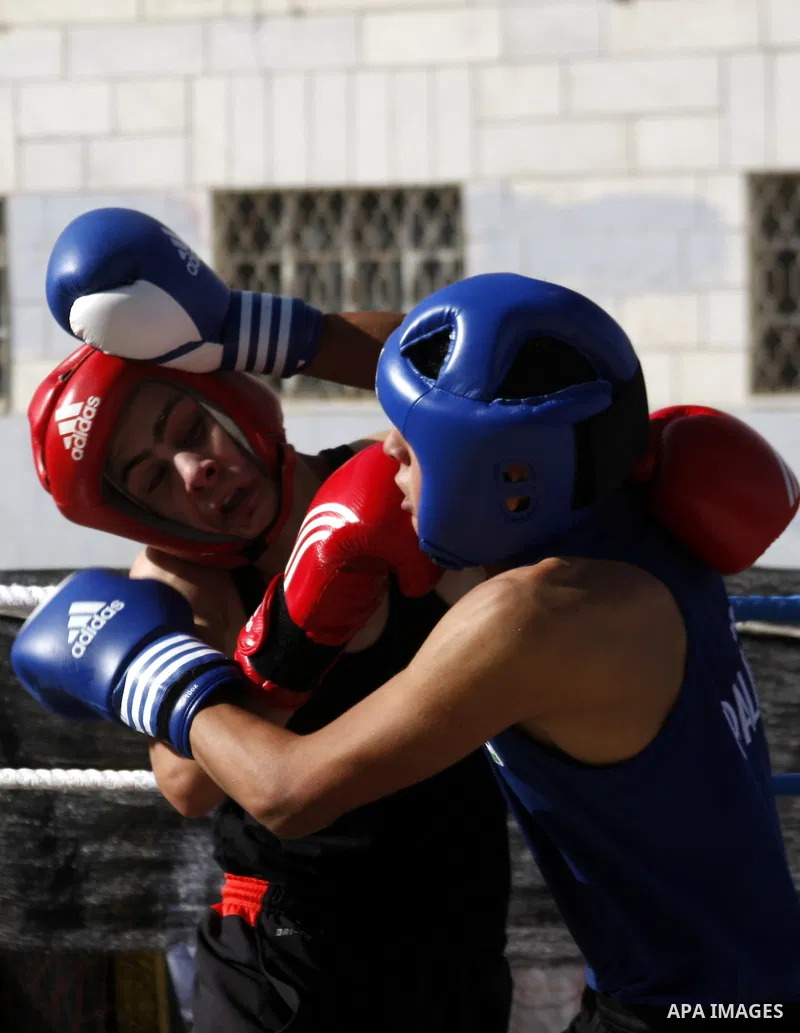 Palestinian players participate in a boxing match in the West Bank city of Hebron on August 6,2010. The players came from the different occupied West Bank cities. Photo by Mamoun Wazwaz