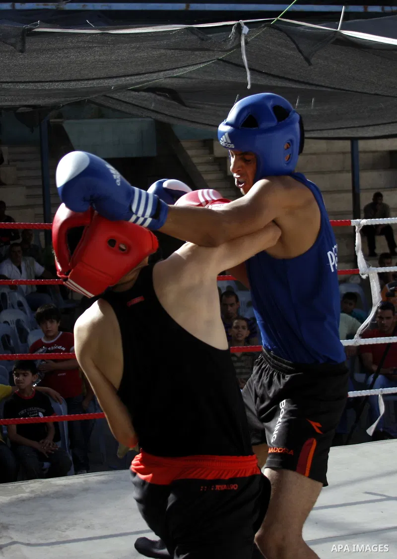 Palestinian players participate in a boxing match in the West Bank city of Hebron on August 6,2010. The players came from the different occupied West Bank cities. Photo by Mamoun Wazwaz