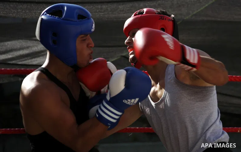 Palestinian players participate in a boxing match in the West Bank city of Hebron on August 6,2010. The players came from the different occupied West Bank cities. Photo by Mamoun Wazwaz