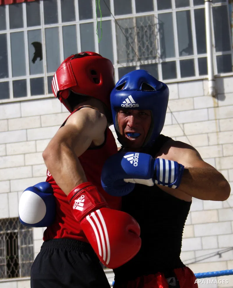 Palestinian players participate in a boxing match in the West Bank city of Hebron on August 6,2010. The players came from the different occupied West Bank cities. Photo by Mamoun Wazwaz