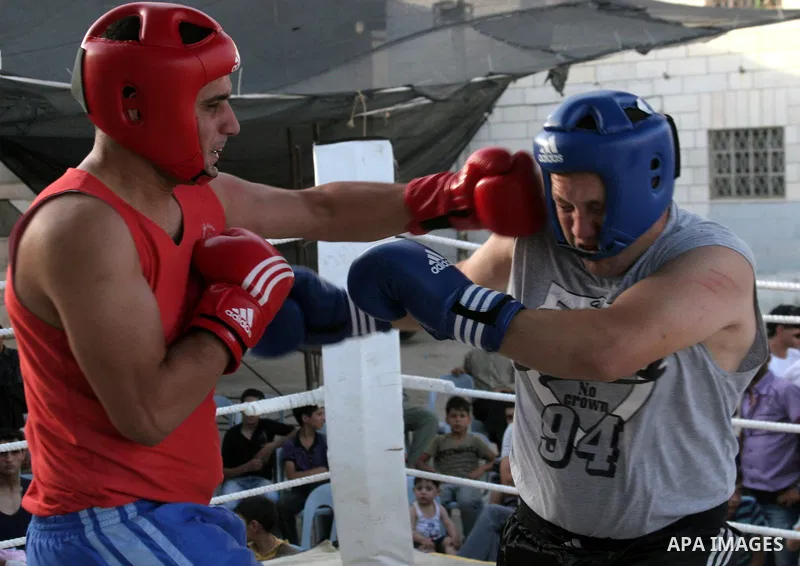 Palestinian players participate in a boxing match in the West Bank city of Hebron on August 6,2010. The players came from the different occupied West Bank cities. Photo by Mamoun Wazwaz