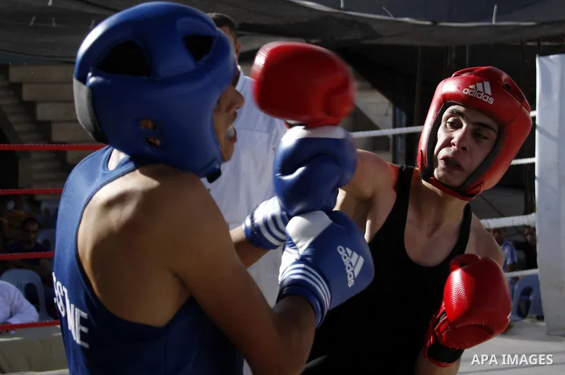 Palestinian players participate in a boxing match in the West Bank city of Hebron on August 6,2010. The players came from the different occupied West Bank cities. Photo by Mamoun Wazwaz