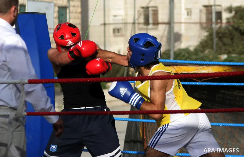 Palestinian players participate in a boxing match in the West Bank city of Hebron on August 6,2010. The players came from the different occupied West Bank cities. Photo by Mamoun Wazwaz