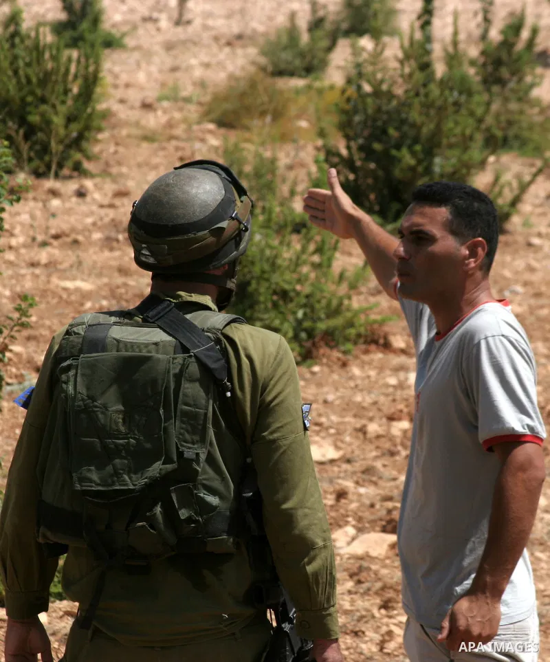 An Israeli soldier argues with a Palestinian protester during a demonstration against Israeli settlements, in the West Bank village of Beit Omar, near Hebron, Saturday, on August 7, 2010.. Photo by Mamoun Wazwaz