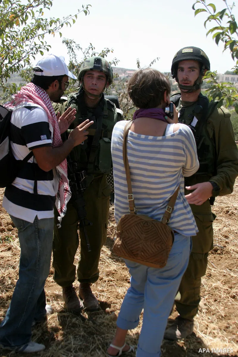 Israeli soldiers argue with protesters during a demonstration against Israeli settlements, in the West Bank village of Beit Omar, near Hebron, Saturday, on August 7, 2010.. Photo by Mamoun Wazwaz