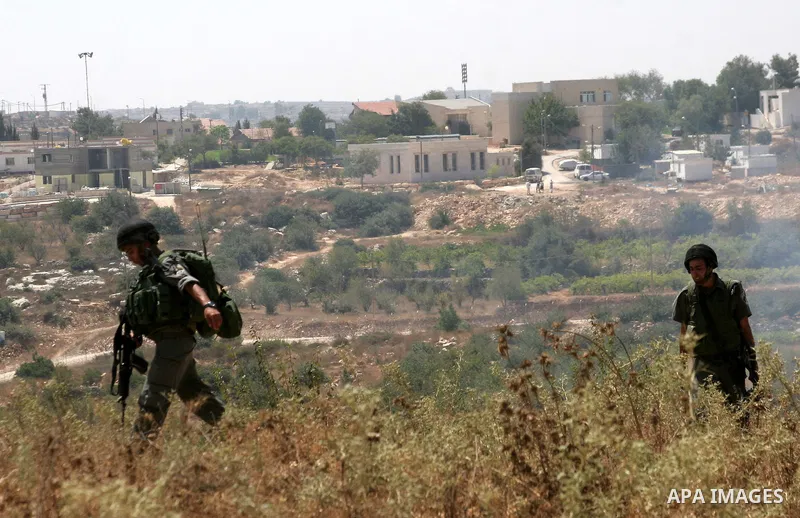 Israeli soldiers patrol during a demonstration by Palestinian protesters against Israeli settlements, in the West Bank village of Beit Omar, near Hebron, Saturday, on August 7, 2010.. Photo by Mamoun Wazwaz