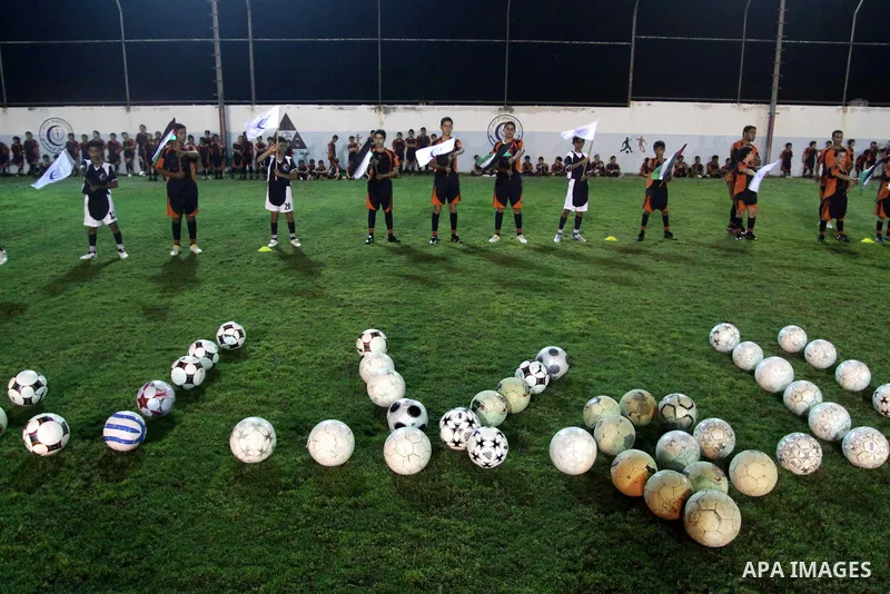 Palestinian children participate in the opening ceremony of the eighth season for football school at Al-Helal (Crescent) club in Gaza city on August 6,2010. Palestinian Children play football to practice their skills and...