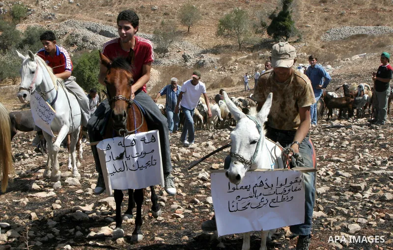 Palestinians ride their donkeys and horses taking part in a protest against the settlers of the nearby Jewish settlement of Itzhar in the village of Burin near the West Bank city of Nablus, Tuesday, Aug. 10, 2010. Burin...