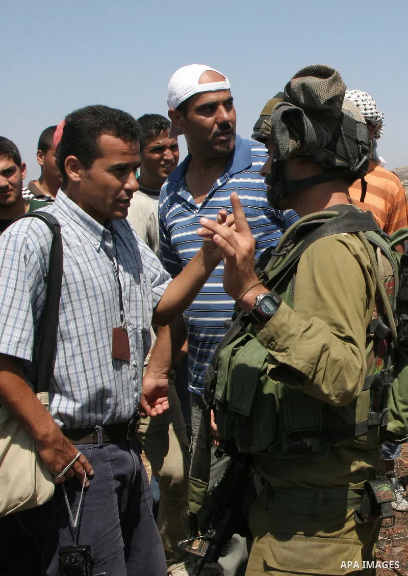 Israeli soldiers argue with Palestinians taking part in a protest against the settlers of the nearby Jewish settlement of Itzhar in the village of Burin near the West Bank city of Nablus, Tuesday, Aug. 10, 2010. Burin is...
