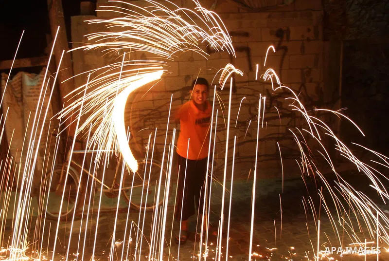 A Palestinian child plays with fireworks on the first day of Ramadan in Gaza city, Wednesday, Aug. 11, 2010. During the Muslim holy month of Ramadan, observant Muslims abstain from eating, drinking and smoking from sunri...