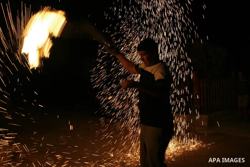 A Palestinian boy plays with fireworks on the second day of Ramadan , in the West Bank city of Nablus, Aug. 12, 2010. During the Muslim holy month of Ramadan, observant Muslims abstain from eating, drinking and smoking f...