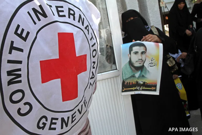 Palestinian women and children hold pictures of jailed relatives during a protest calling for the release of Palestinian prisoners from Israeli jails at the Red Cross office in Gaza City on August 23,2010. Photo by Ashra...