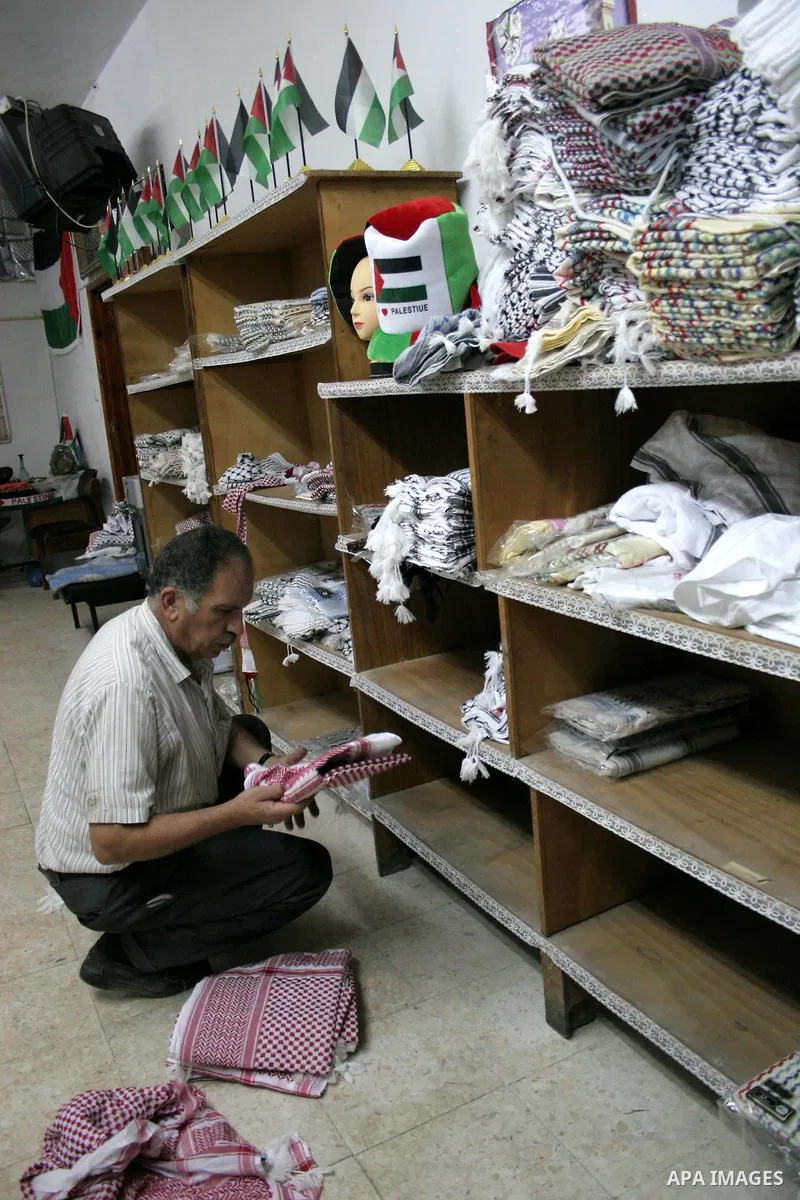 Palestinian Gawdat Hirbawi works at his kufiyeh factory 'Hirbawi kufiyeh' in the West Bank city of Hebron on 29 August 2010. Kufiyeh is a traditional headdress typically worn by Arab men made of a square of cloth ("scarf...